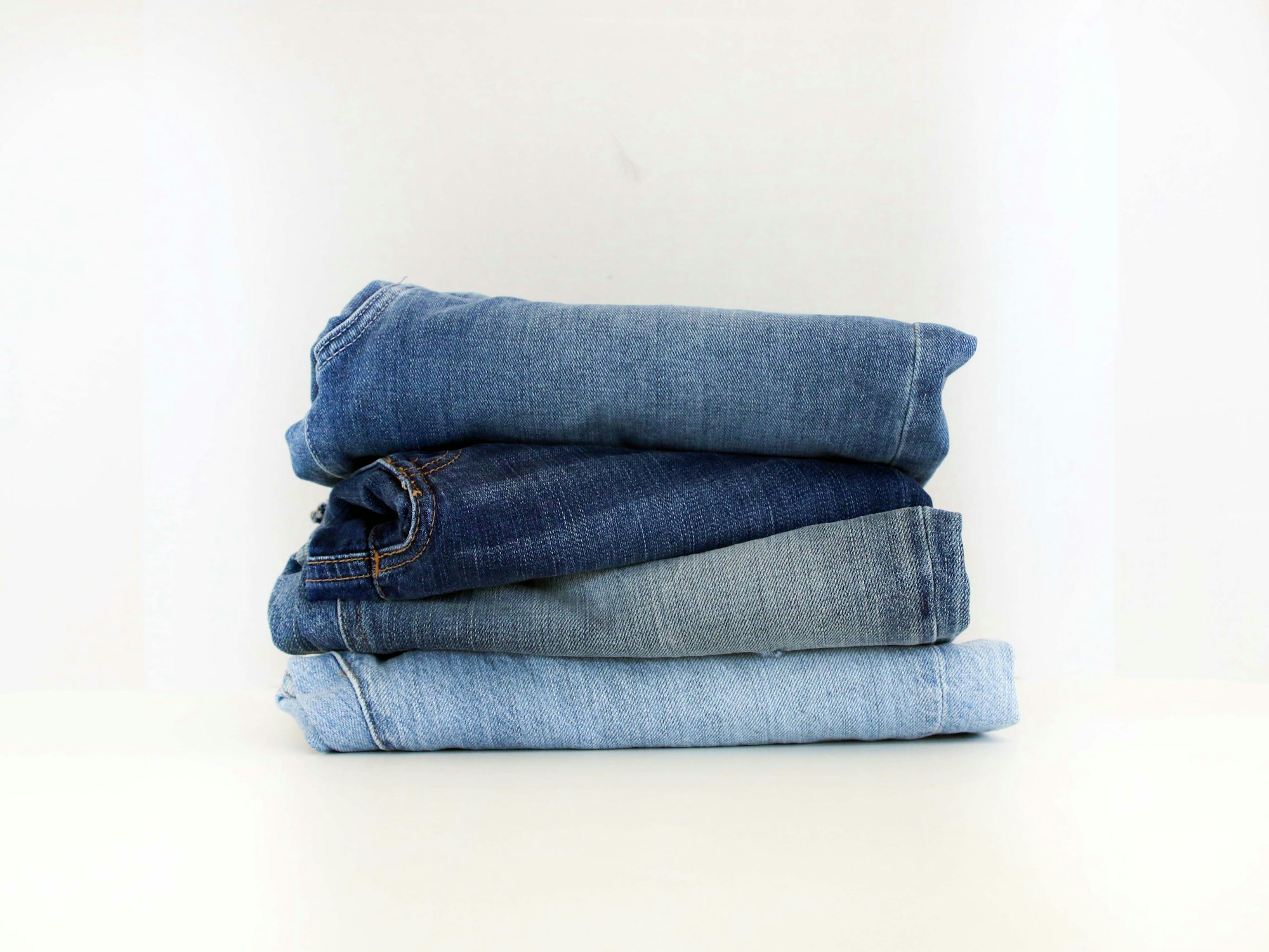 folded jeans in several washes