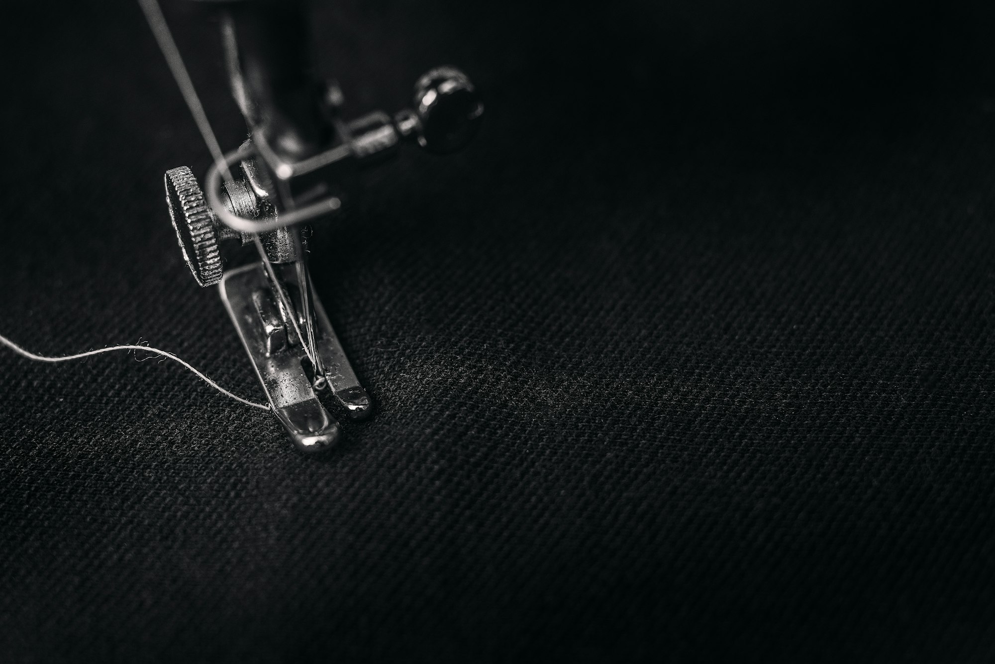 sewing machine foot stitching dark cloth