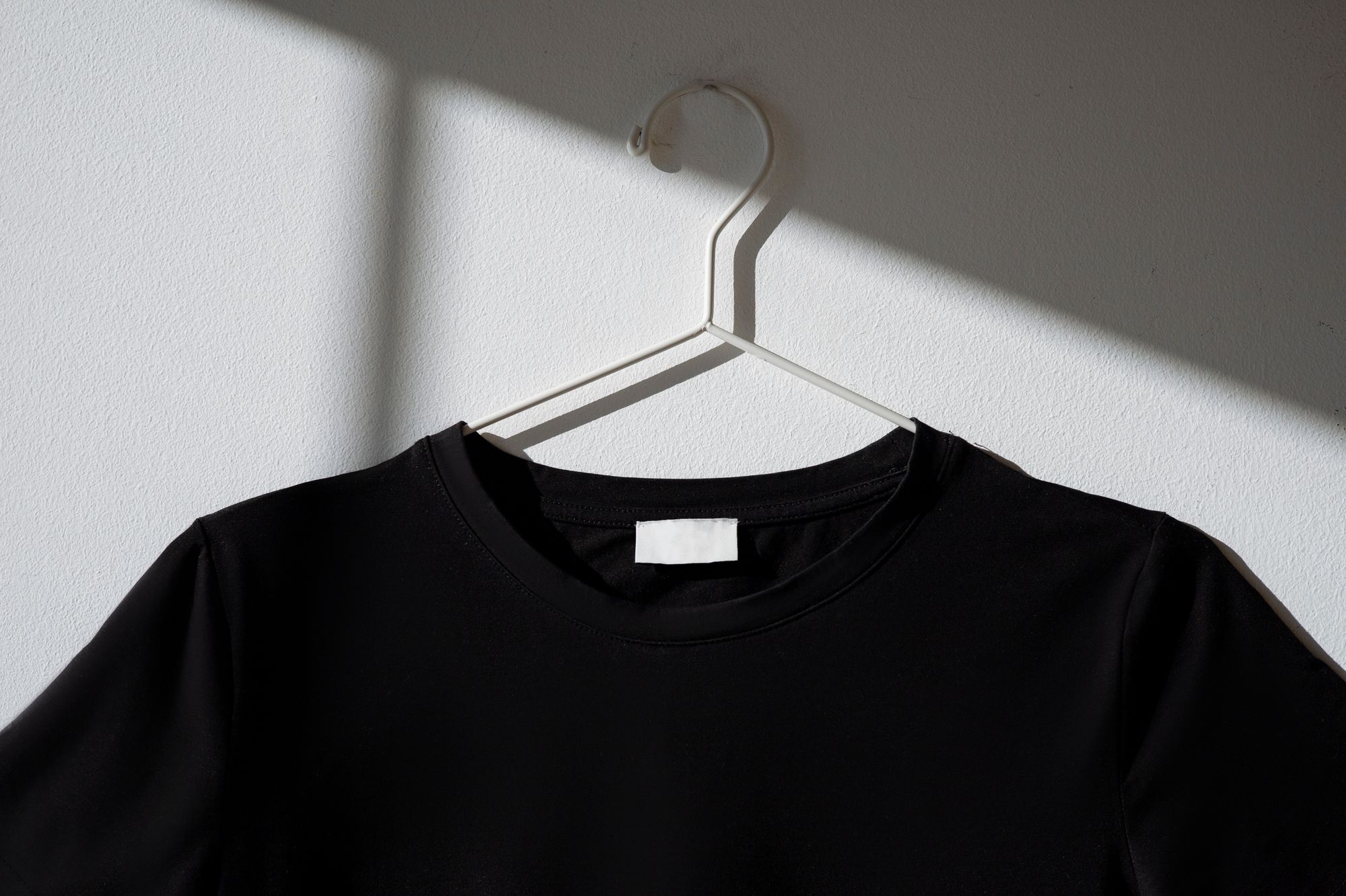 black t-shirt on a white hanger