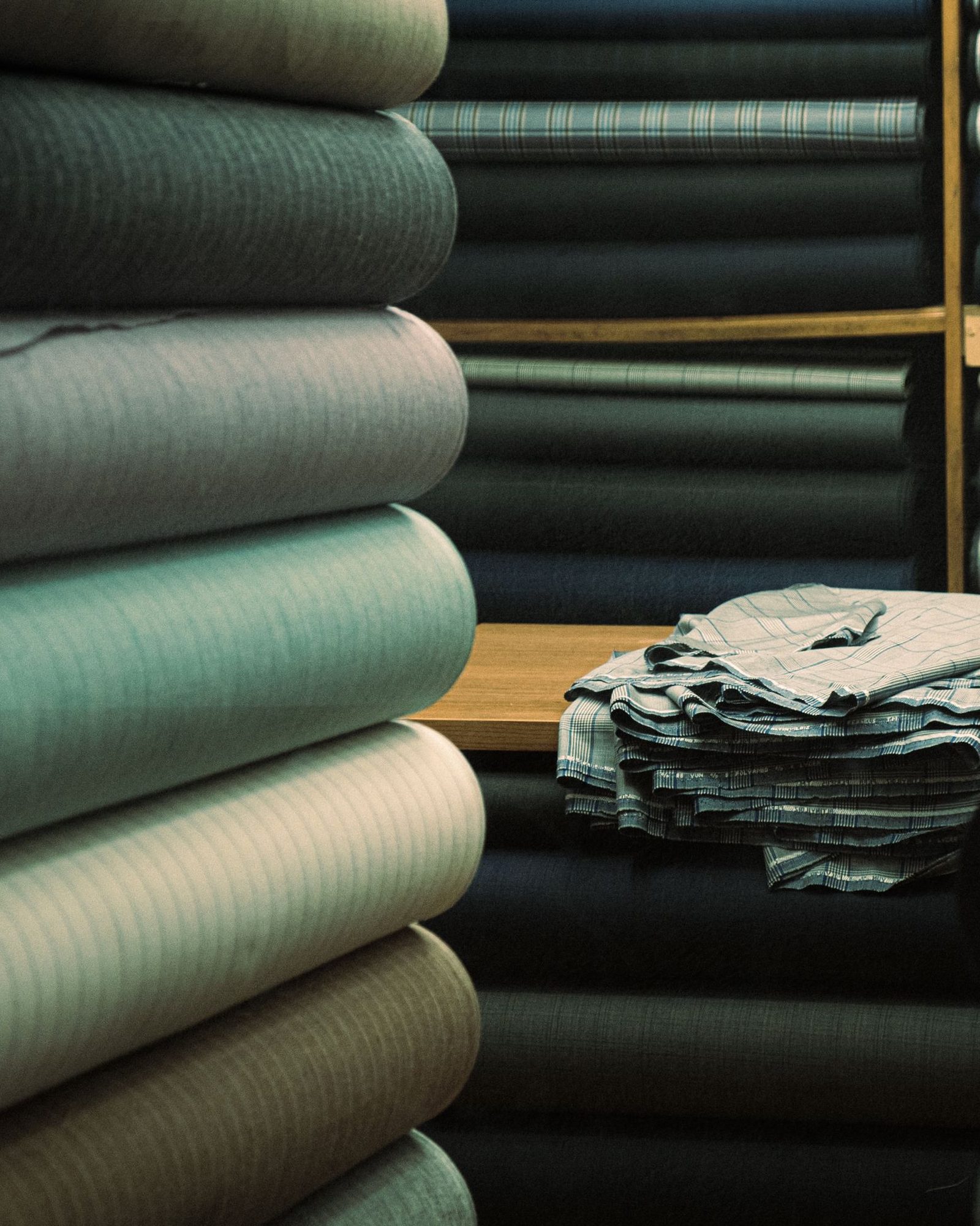 wool suiting cloth rolled and stacked on mill shelves