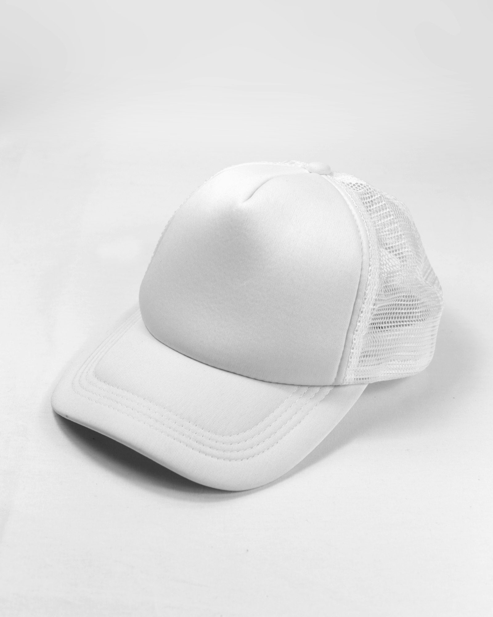 plain white cap on a white surface