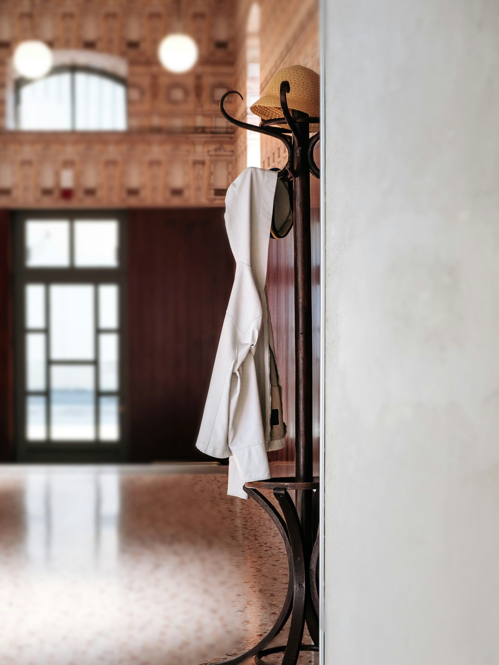 white uniform jacket on a coat stand in a hotel hallway